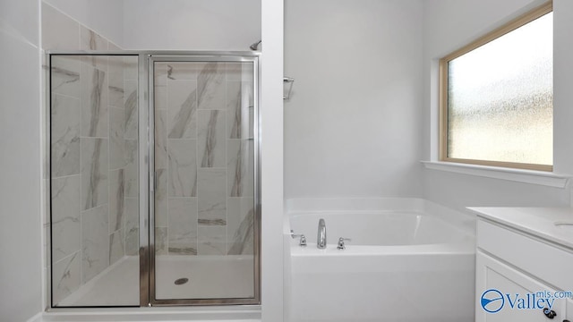 bathroom with vanity and independent shower and bath