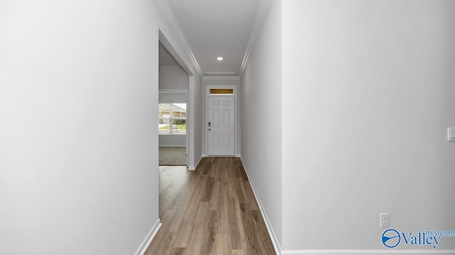 hallway featuring light hardwood / wood-style flooring and ornamental molding