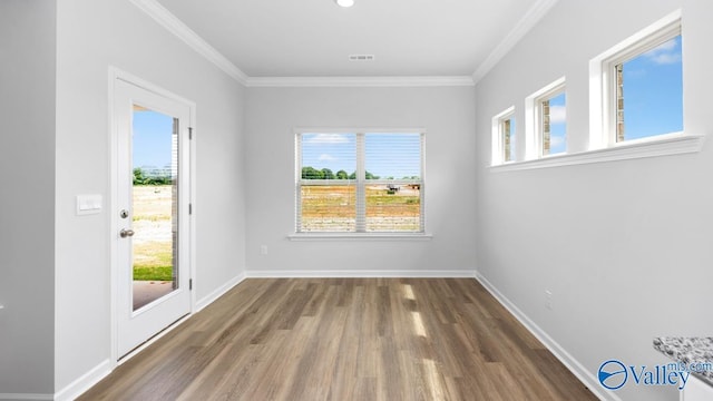 empty room with dark hardwood / wood-style floors and ornamental molding