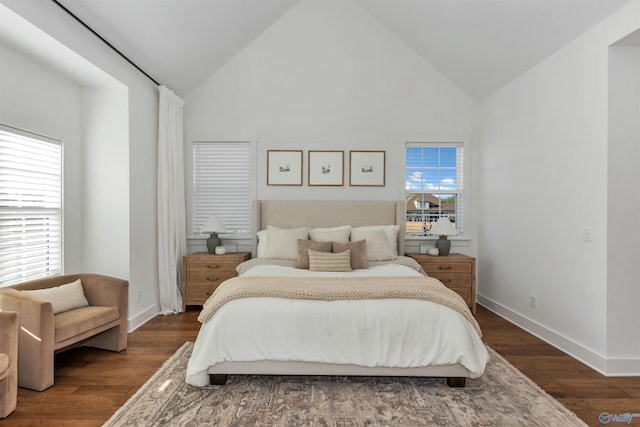 bedroom with high vaulted ceiling and dark wood-type flooring