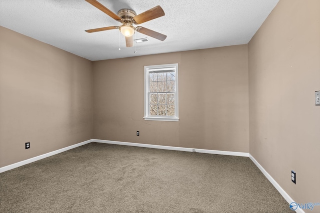 carpeted spare room with a textured ceiling, ceiling fan, visible vents, and baseboards