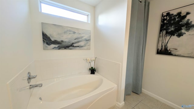 bathroom with a bathing tub and tile patterned flooring