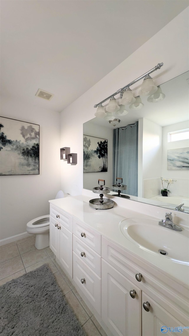 bathroom featuring tile patterned flooring, vanity, and toilet