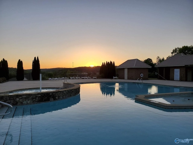 view of pool at dusk