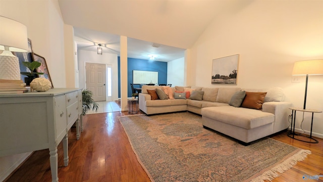 living room with hardwood / wood-style flooring and high vaulted ceiling