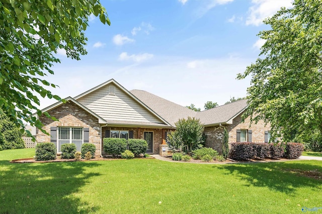 105 Cherrywood Dr, Madison, AL 35756 - view of front of house featuring brick siding, a front yard, and roof with shingles