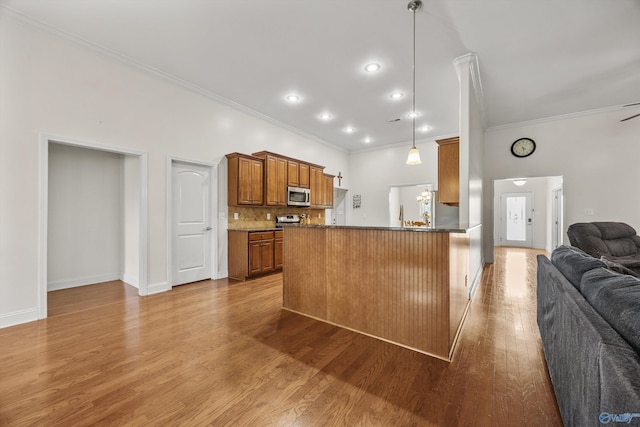 105 Cherrywood Dr, Madison, AL 35756 - kitchen with open floor plan, stainless steel appliances, crown molding, brown cabinets, and backsplash
