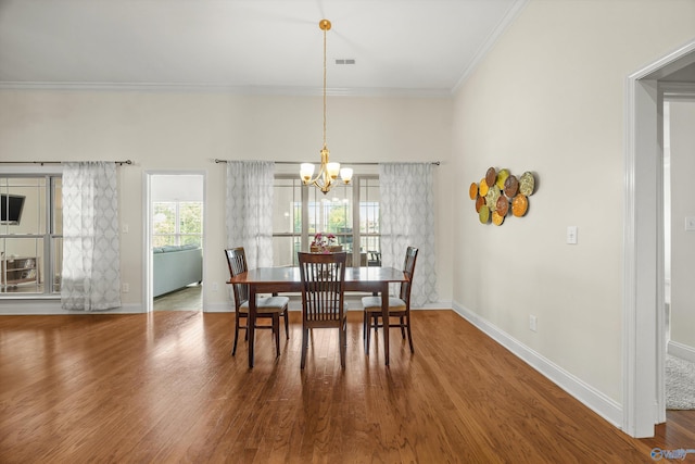 105 Cherrywood Dr, Madison, AL 35756 - dining area with a chandelier, ornamental molding, and wood finished floors