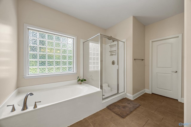 105 Cherrywood Dr, Madison, AL 35756 - bathroom featuring a garden tub, a shower stall, and tile patterned flooring