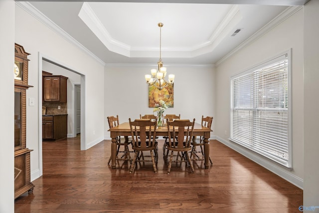 105 Cherrywood Dr, Madison, AL 35756 - dining space featuring a tray ceiling, a chandelier, dark wood-style floors, and ornamental molding