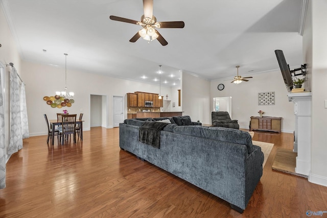 105 Cherrywood Dr, Madison, AL 35756 - living room with a ceiling fan, a chandelier, light wood-style floors, and crown molding