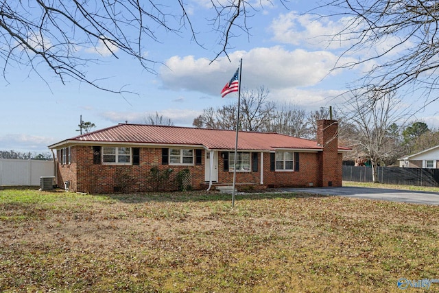 single story home with central AC unit and a front yard