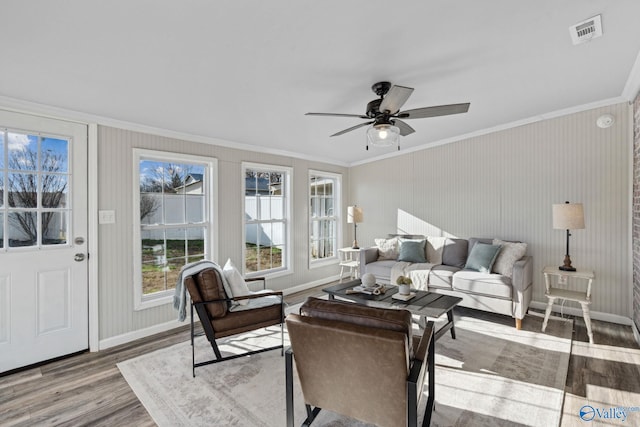 living room featuring crown molding, ceiling fan, and wood-type flooring