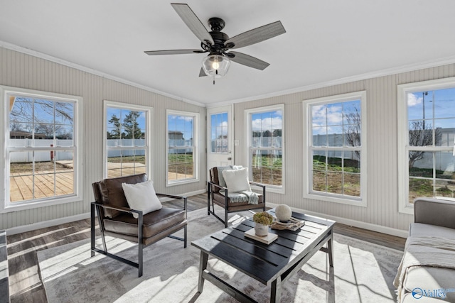 sunroom / solarium featuring ceiling fan