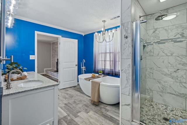 bathroom with hardwood / wood-style floors, vanity, ornamental molding, and plus walk in shower