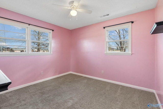 unfurnished room featuring ceiling fan and carpet floors