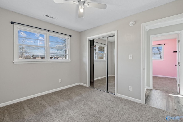 unfurnished bedroom featuring carpet, ceiling fan, and a closet