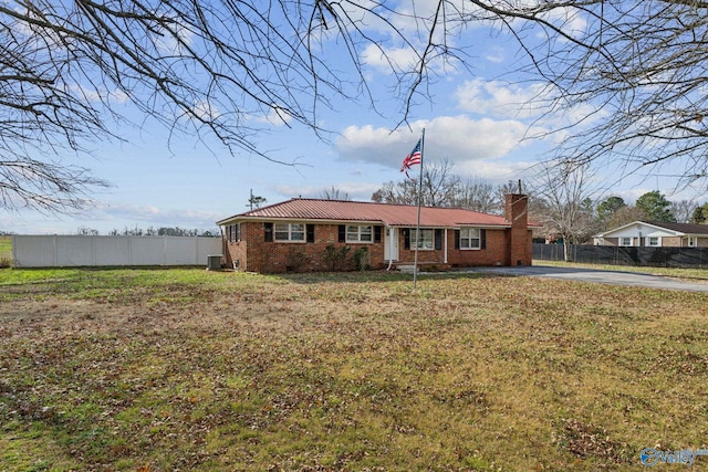 ranch-style home with a front lawn