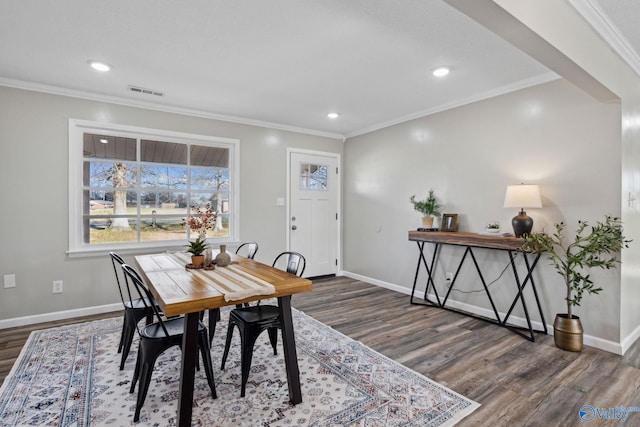 dining area featuring dark hardwood / wood-style flooring and ornamental molding