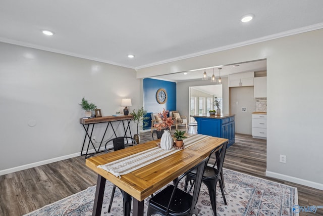 dining area with dark hardwood / wood-style flooring and crown molding