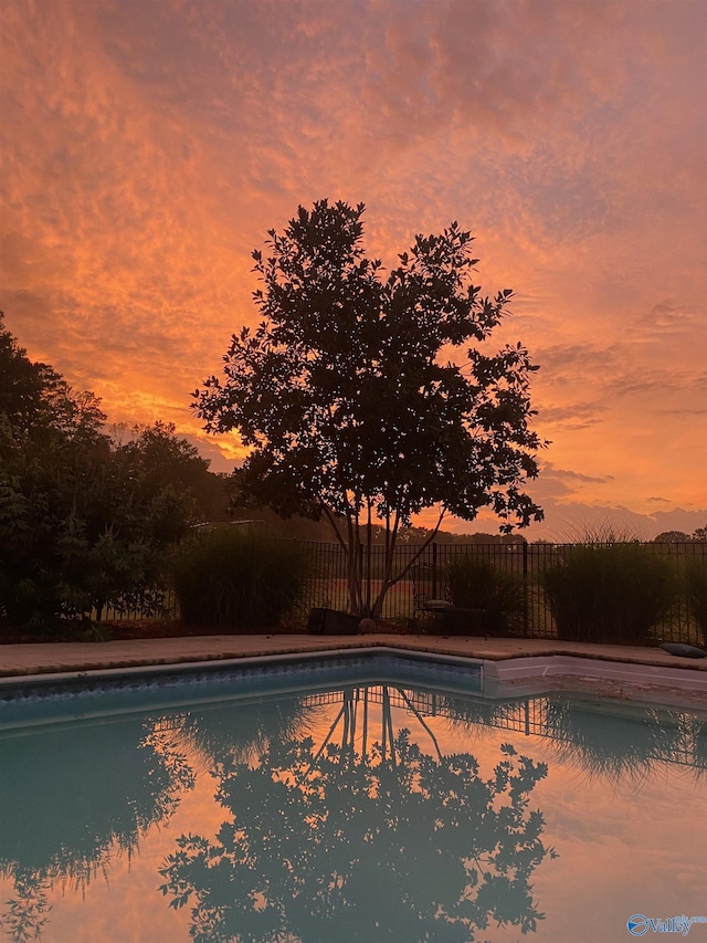 view of pool with a fenced in pool and fence