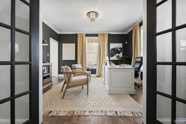 home office featuring a textured ceiling, wood finished floors, and crown molding