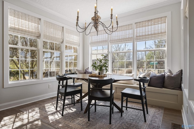 dining area with plenty of natural light, a notable chandelier, visible vents, and ornamental molding