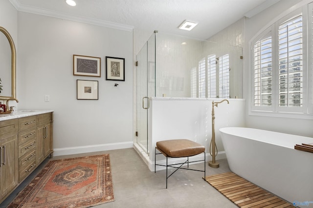 full bathroom with a stall shower, ornamental molding, baseboards, a soaking tub, and vanity