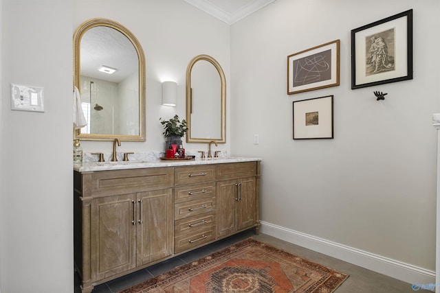 full bath featuring double vanity, ornamental molding, baseboards, and a sink