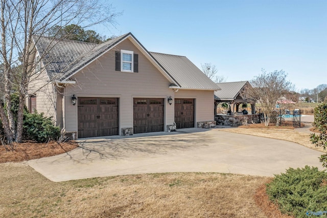 view of front of house with metal roof and concrete driveway