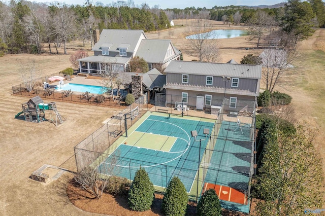 view of basketball court with an outdoor pool, community basketball court, and fence