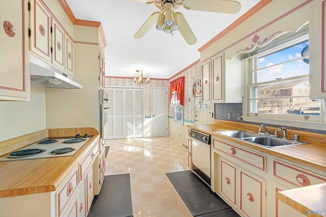 kitchen featuring white appliances, wallpapered walls, crown molding, under cabinet range hood, and a sink