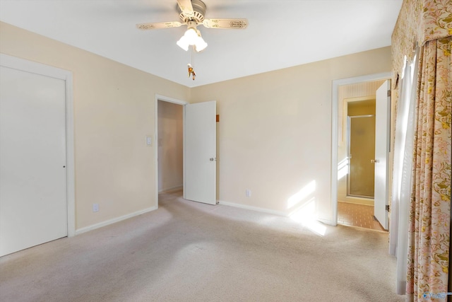 unfurnished room with carpet floors, a ceiling fan, and baseboards