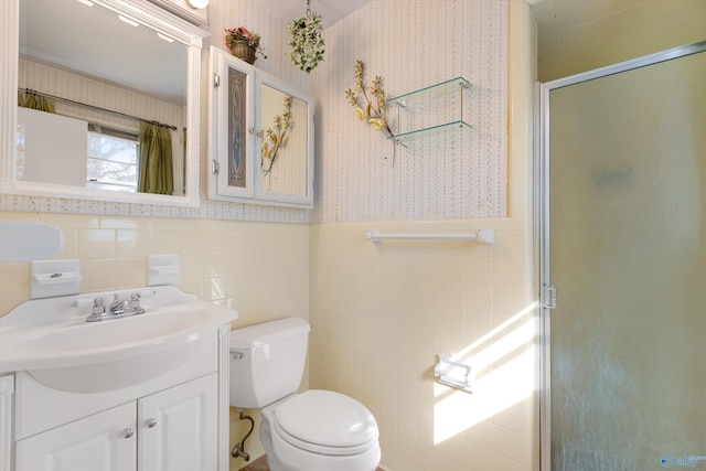 full bath with toilet, wallpapered walls, a stall shower, and wainscoting