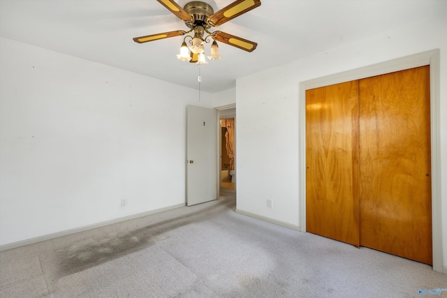 unfurnished bedroom with carpet floors, a ceiling fan, baseboards, and a closet