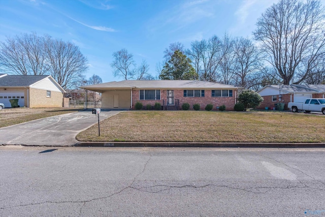 ranch-style home featuring an attached carport, brick siding, driveway, and a front yard