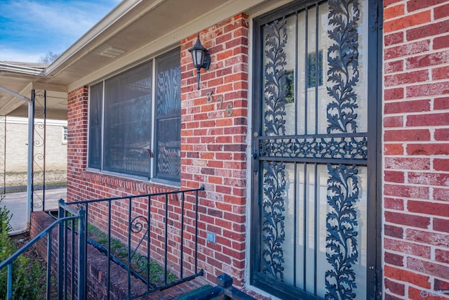 property entrance with brick siding