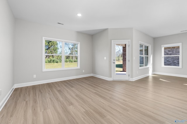 empty room with light hardwood / wood-style floors