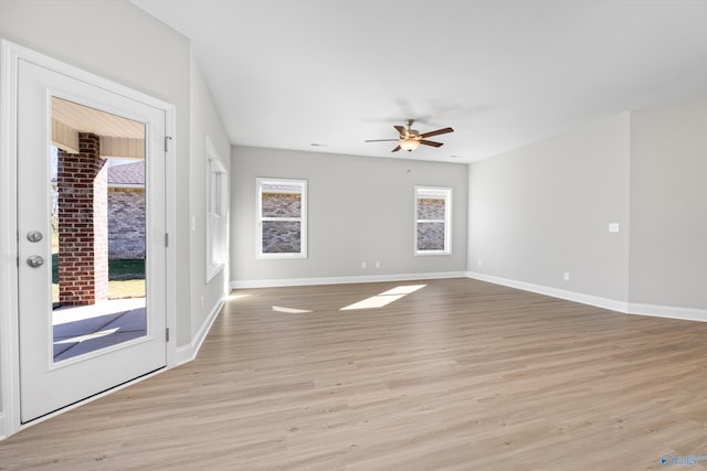 spare room featuring ceiling fan and light hardwood / wood-style flooring