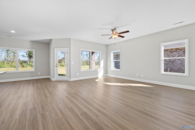 unfurnished living room with ceiling fan and light wood-type flooring