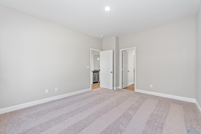 unfurnished bedroom featuring light carpet