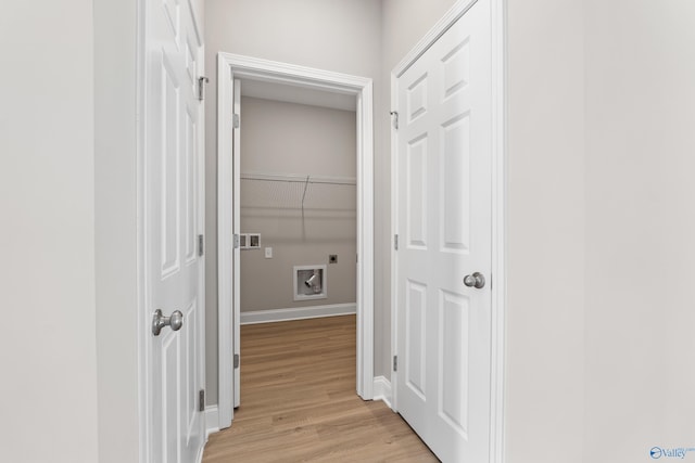 hallway with light hardwood / wood-style flooring