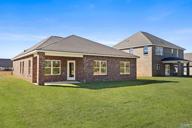 back of house with a patio and a lawn