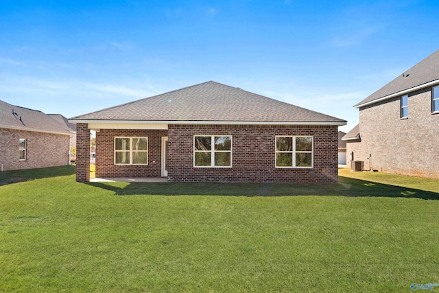 rear view of property with a lawn and a patio area