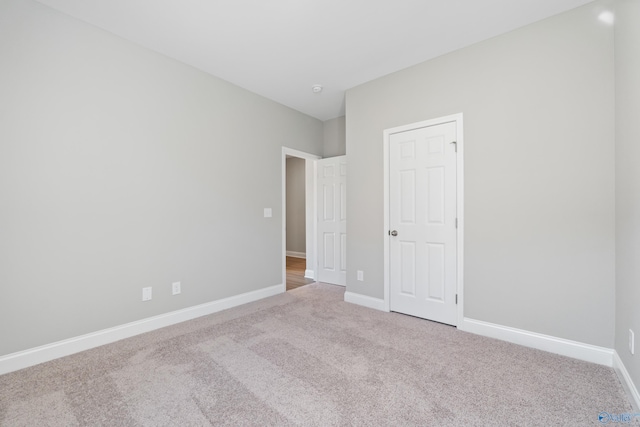 unfurnished bedroom with light colored carpet