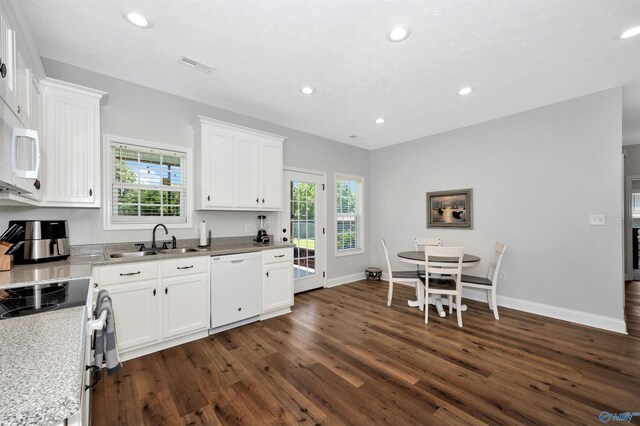 16290 Log Cabin Rd, Athens, AL 35611 - kitchen with white appliances, a sink, dark wood-style floors, white cabinets, and plenty of natural light