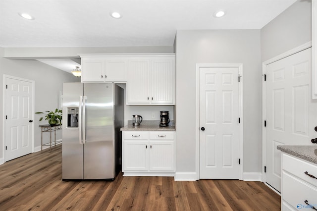 16290 Log Cabin Rd, Athens, AL 35611 - kitchen featuring stainless steel fridge, dark wood-type flooring, white cabinetry, light stone countertops, and recessed lighting