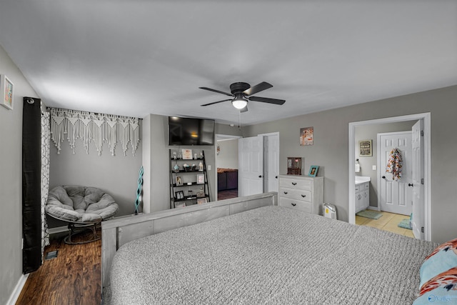 bedroom with ceiling fan, light hardwood / wood-style floors, and ensuite bathroom