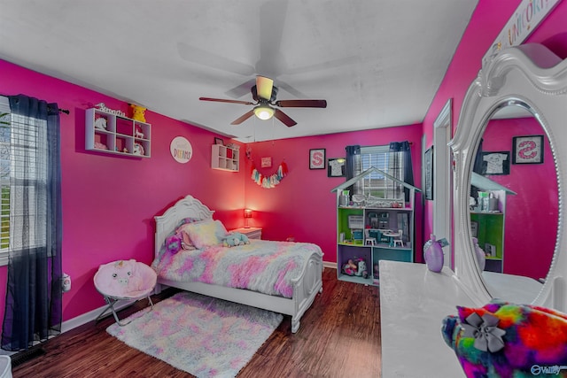 bedroom with ceiling fan and dark wood-type flooring