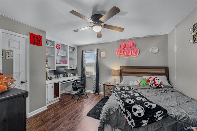 bedroom with ceiling fan, dark hardwood / wood-style floors, and built in desk